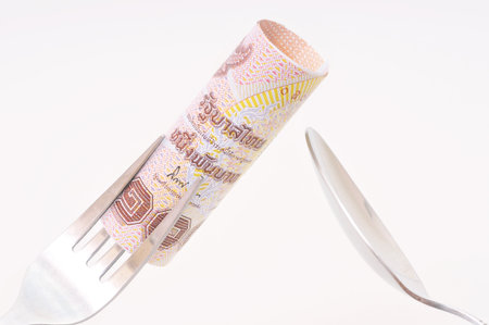 High price of food concept  Eating money for dinnerの写真素材