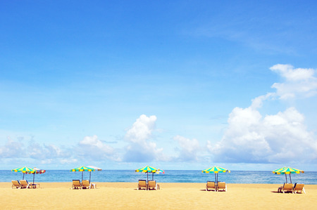 Beach chairs with umbrella and beautiful beach on a sunny dayの写真素材