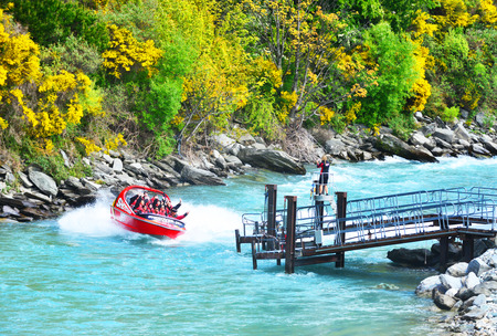 QUEENSTOWN, NEW ZEALAND -  November 18: Tourists enjoy a high-speed boat ride on Queenstownのeditorial素材