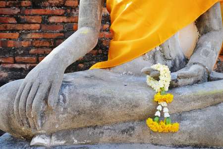 Flower garland in buddha image hand in a temple ayutthayaThailand.の写真素材