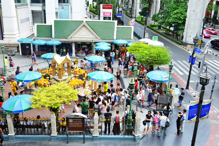 BANGKOK - 8 July, 2015: The Golden four-faced Brahma Shrine Phra Phrom at the Erawan, Ratchaprasong Road, Thailand. This statue is really famous attracts a plethora of visitors in each year.のeditorial素材
