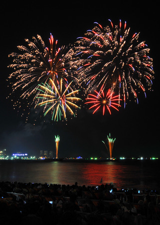 Multicolor fireworks night scene, closeup with pattaya cityscape sea beach view, thailandの写真素材