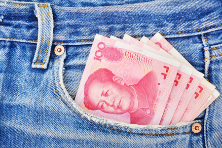 Banknotes of one hundred yuan in the jeans pocketの写真素材