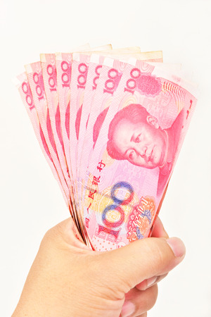 hand with 100 Yuan banknotesの写真素材