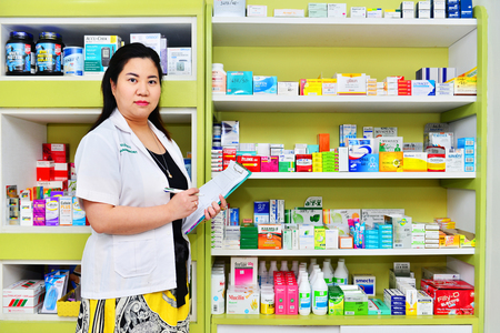 Bangkok,Thailand - JAN 9:Asian pharmacist chemist woman standing in pharmacy drugstore on JAN 9,2016 in Bangkok,Thailand.Over 12,123 pharmacy drugstore in Thailand.のeditorial素材