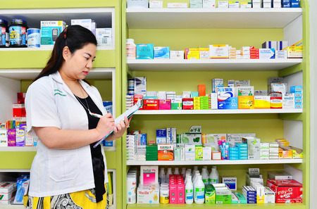 Bangkok,Thailand - JAN 9:Asian pharmacist chemist woman standing in pharmacy drugstore on JAN 9,2016 in Bangkok,Thailand.Over 12,123 pharmacy drugstore in Thailand.のeditorial素材