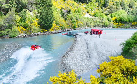 QUEENSTOWN, NEW ZEALAND - November 18: Tourists enjoy a high-speed boat ride on Queenstown's Shotover river on November 18, 2014 in Queenstown, New Zealand. Queenstown is a popular alpine resortのeditorial素材