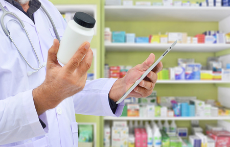 Pharmacist filling prescription in pharmacy drugstoreの写真素材