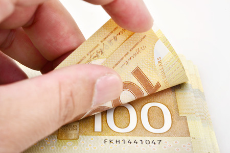 Hand holding canadian banknote