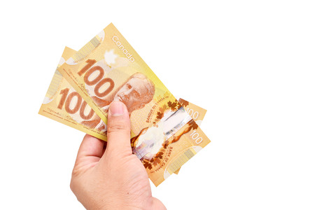 Hand holding canadian banknoteの写真素材