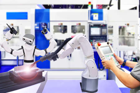 Engineer check and control modern high quality automation welding robots arm at industrial