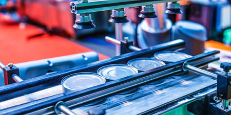 Canned food products on conveyor belt in distribution warehouse. parcels transportation system...
