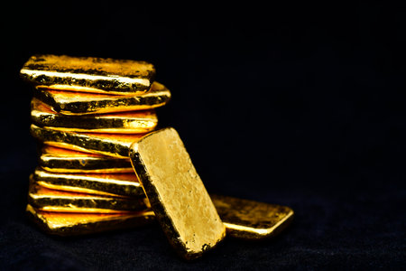 Close up photo a gold bars on black background,copy spaceの写真素材