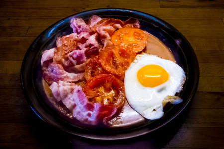 Breakfast with egg, bacon and tomatoesの写真素材