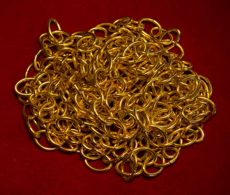 Gold chain on red velvet