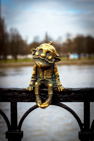 Bronze figure of grandfather sitting on the bridgeの写真素材