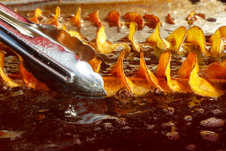 Potatoes are fried in boiling oilの写真素材