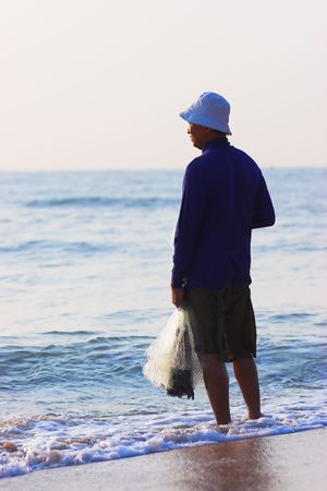 Thai fisherman at sunrise in the Gulf of Thailandの写真素材