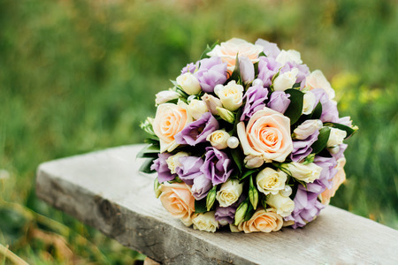 Wedding bouquet lies on the bench.の写真素材
