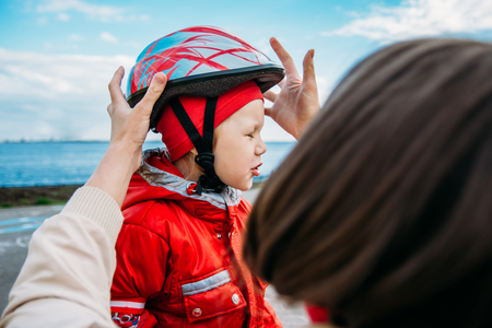 woman wears a helmet your child for skatingの写真素材