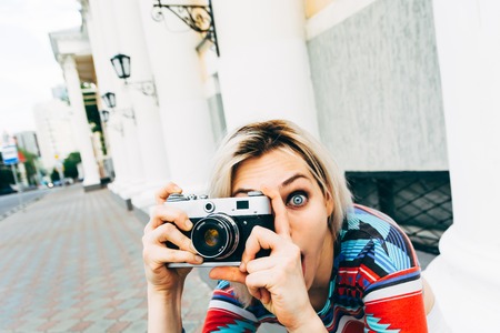 beautiful girl retro camera shoots the worldの写真素材