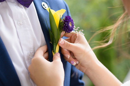 groom boutonniere helps to put her fiance