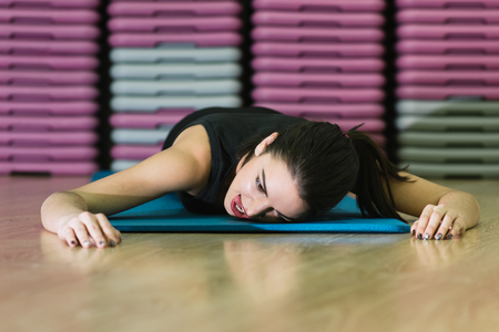 girl goes in for sports on a rugの写真素材