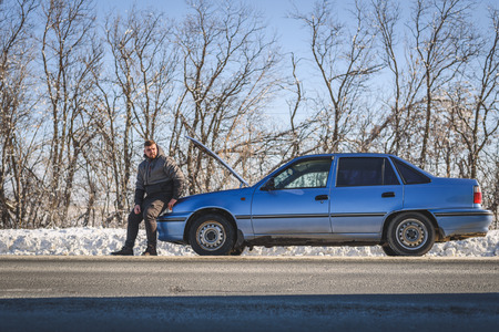 man tries to stop the car in winterの写真素材