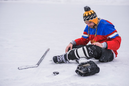tired player sitting on the ice oneの写真素材