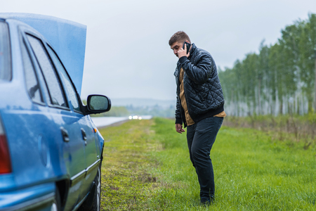 Alarmed driver calls the help desk by phoneの写真素材