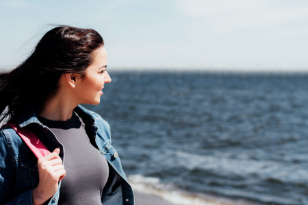 Beautiful tourist girl resting on the waterfrontの写真素材