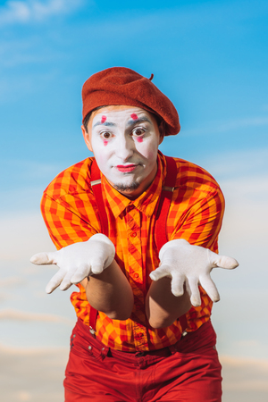 Actor shows pantomime against the blue skyの写真素材