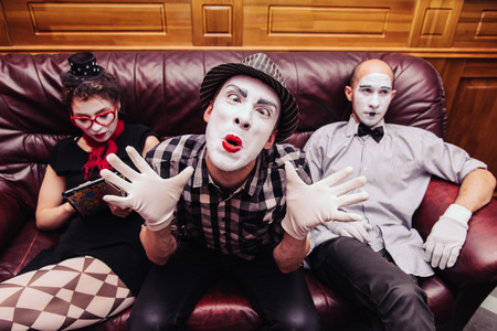 Mimes rest on the couch after the performanceの写真素材