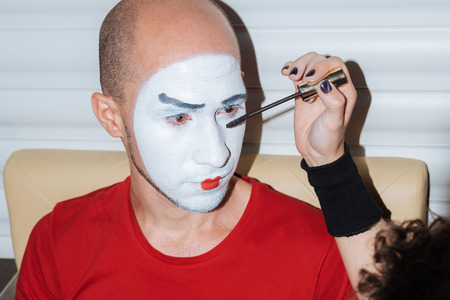 beautiful mimi girl makes make-up for her companionの写真素材