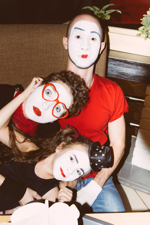 a family of mimes photographed in coffee after a speechの写真素材