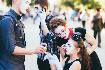 a family of mimes is preparing for a show on the streetの写真素材