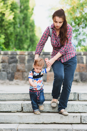 Mothers teach to walk on the road