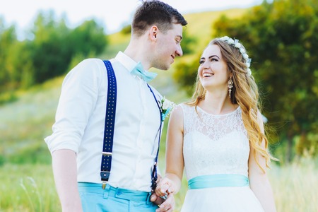 the bride and groom are photographed at sunsetの写真素材