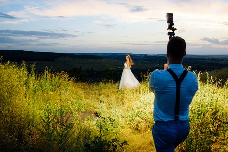 the bride and groom are photographed at sunsetの写真素材