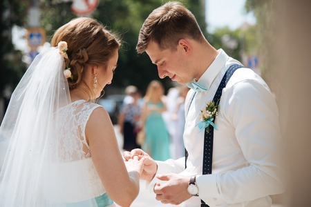 the bride and groom rehearse putting rings near the registry office the dayの写真素材