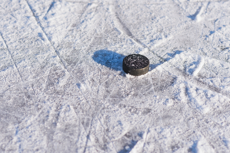 hockey puck lies on ice during the day
