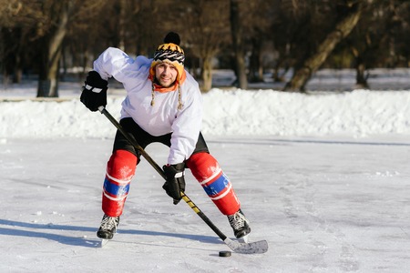 man in ice skates plays in hockey at the stadium