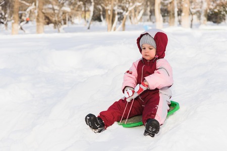 the child moves off the hill on the sled