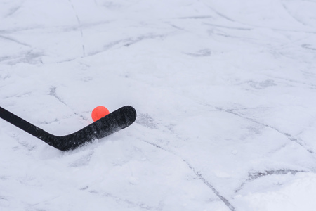 Green stick and orange ball for hockeyの写真素材