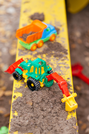 children's toys in the sandbox in autumn close-upの写真素材