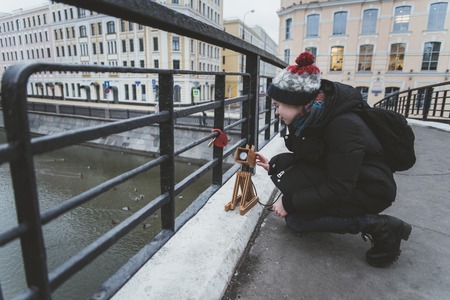 the girl is playing on the street with an imaginary dog that is actually luminouの写真素材