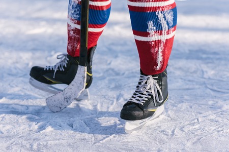 hockey players legs close-up during a game on iceの写真素材