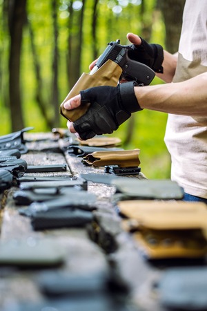 the guy in the woods is cleaning his weaponの写真素材