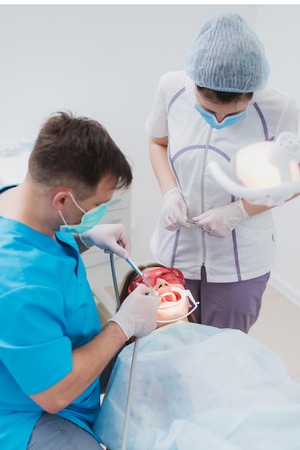 doctor performs the procedure for cleaning teeth