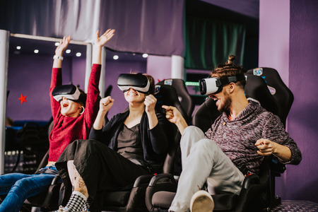 friends in virtual glasses watching movies in the cinema with special effects